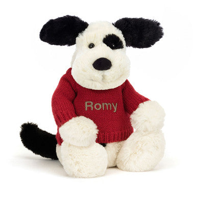 Chiot timide noir et crème avec pull rouge personnalisé